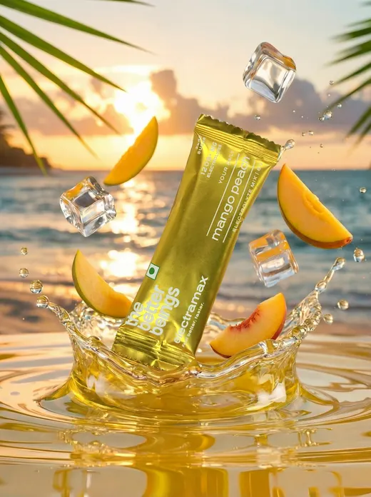 Gold mango-peach drink sachet bursting from a golden splash with ice cubes and peach slices on a sunset beach